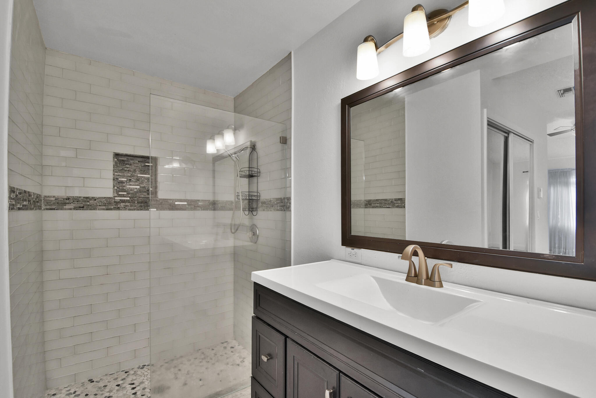 13175 Quiet Woods Road, Unit A Wellington, FL 33414 - Photo 15 of 46 a bathroom with a granite countertop sink a mirror and a shower