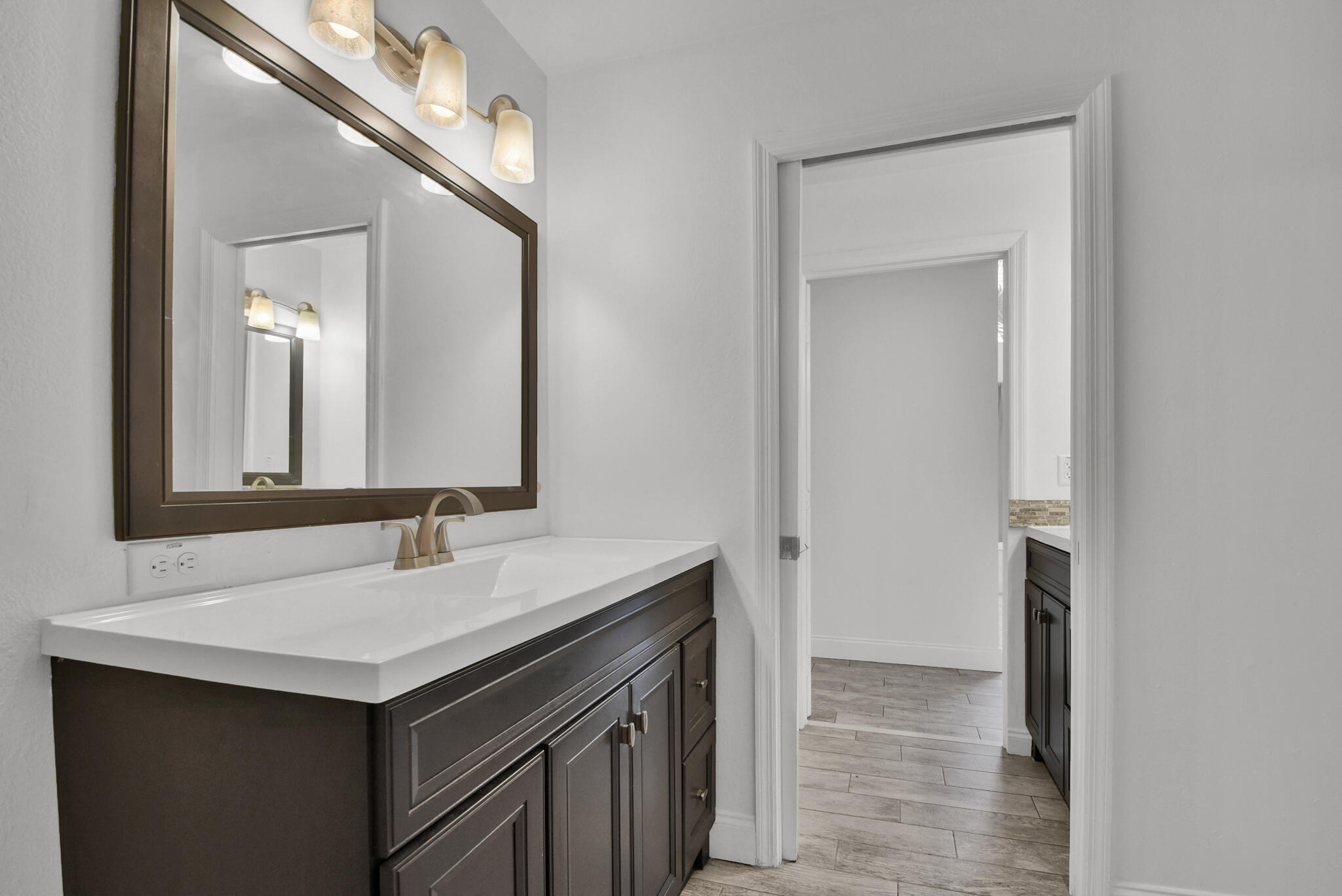 13175 Quiet Woods Road, Unit A Wellington, FL 33414 - Photo 16 of 46 a bathroom with a sink and a mirror