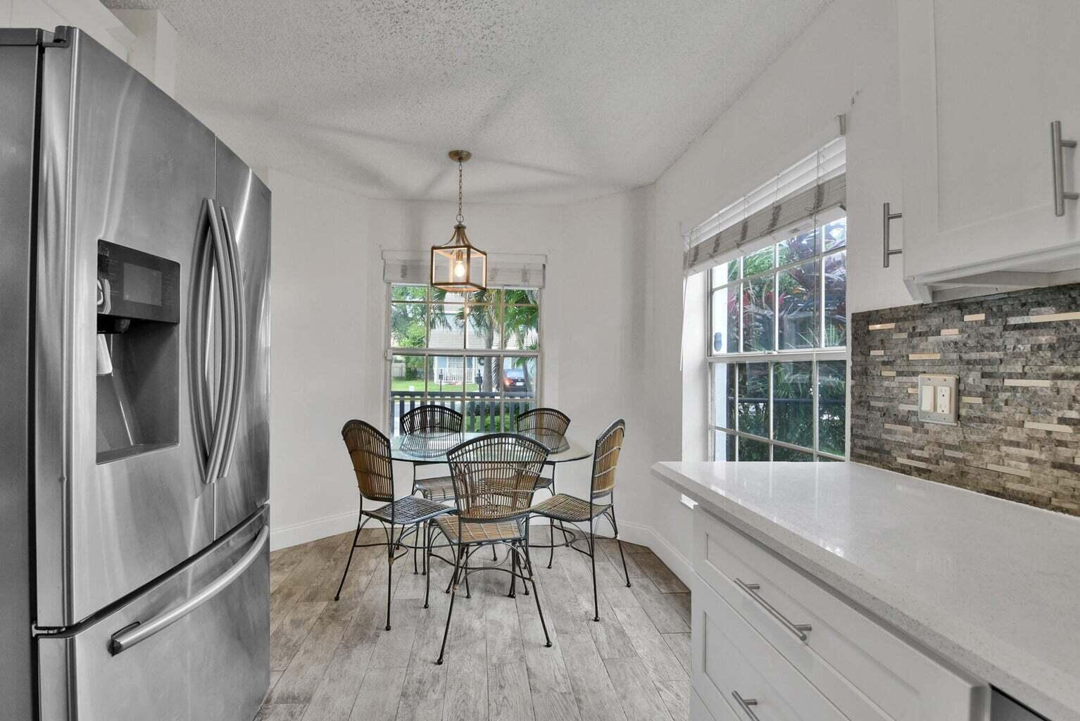 13175 Quiet Woods Road, Unit A Wellington, FL 33414 - Photo 20 of 46 a view of a dining room with furniture window and outside view