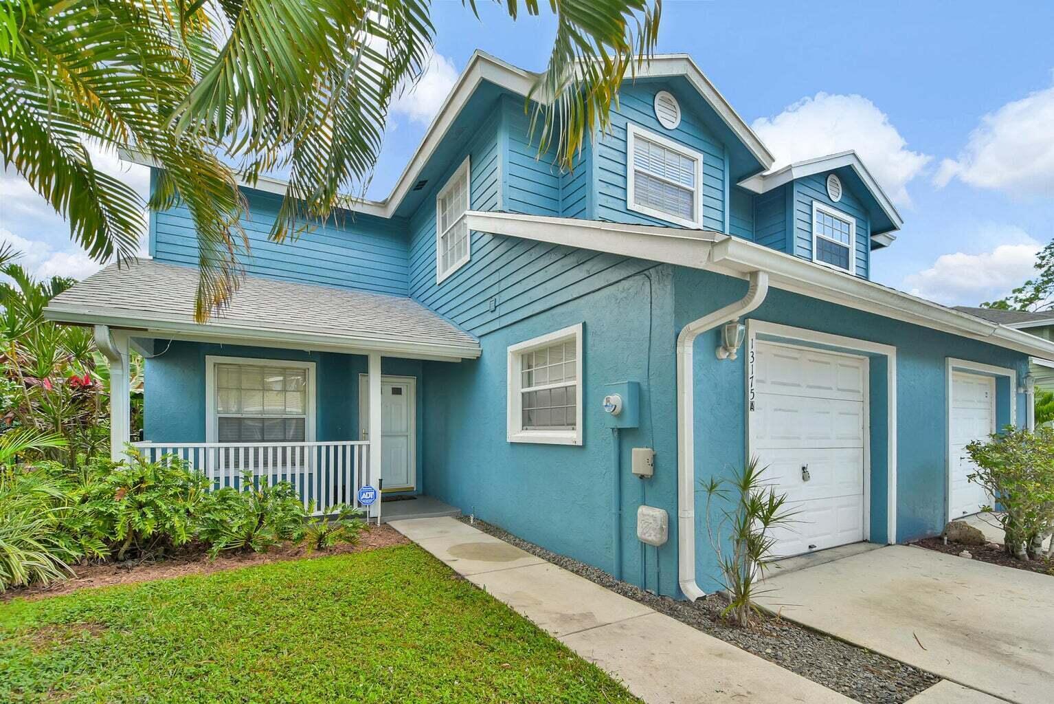 13175 Quiet Woods Road, Unit A Wellington, FL 33414 - Photo 3 of 46 a front view of a house with a garden