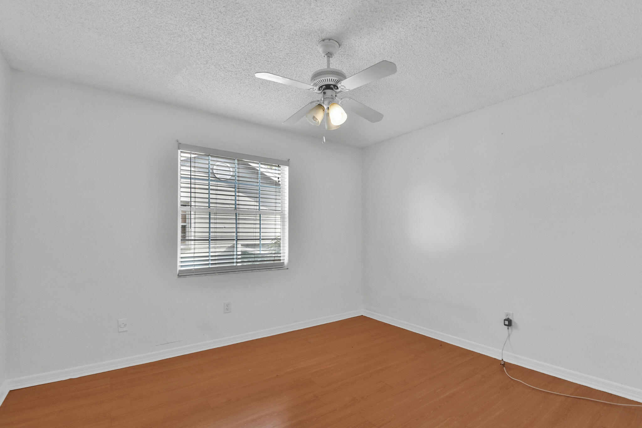 13175 Quiet Woods Road, Unit A Wellington, FL 33414 - Photo 32 of 46 an empty room with a window and a fan