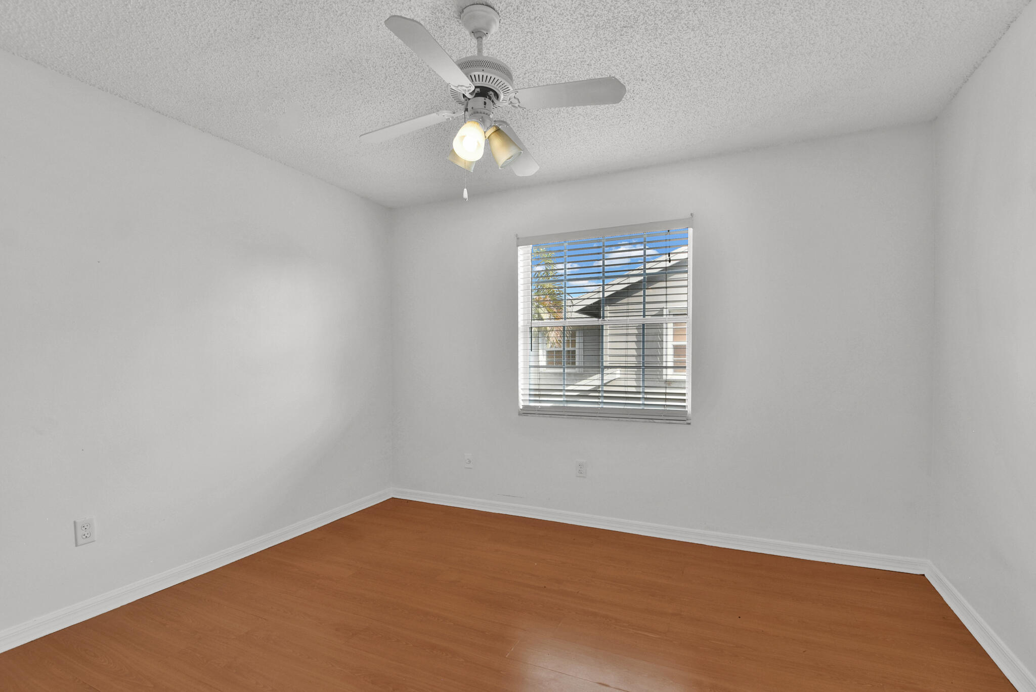 13175 Quiet Woods Road, Unit A Wellington, FL 33414 - Photo 34 of 46 an empty room with windows and fan