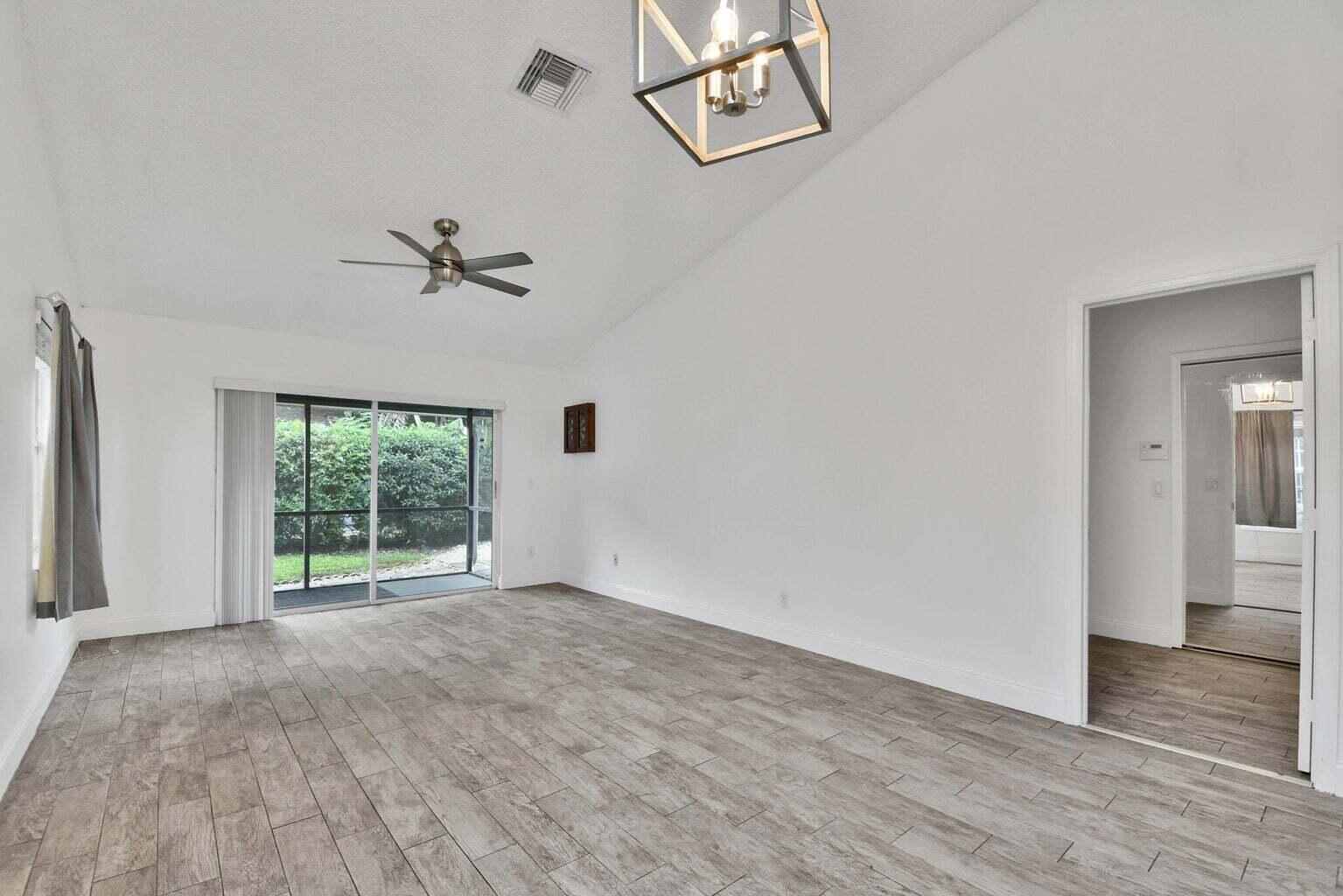 13175 Quiet Woods Road, Unit A Wellington, FL 33414 - Photo 7 of 46 an empty room with windows and closet
