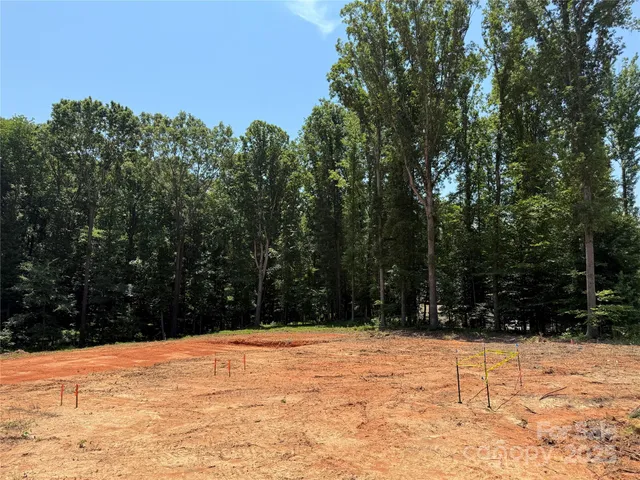 a view of white house with a yard