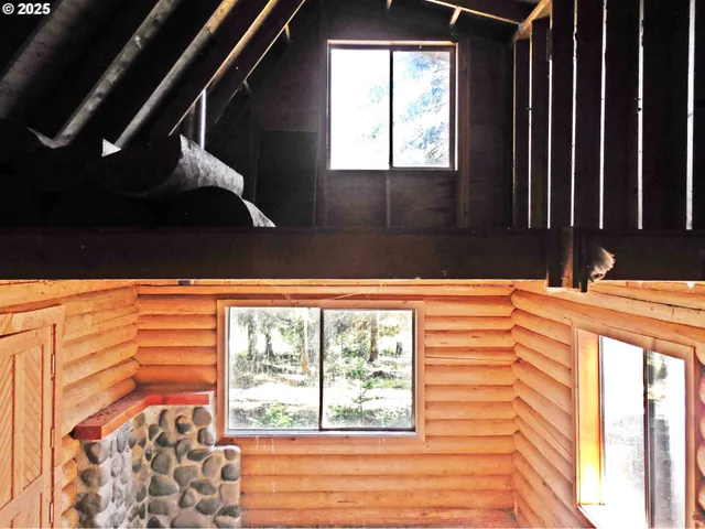 a view of walk in closet and wooden floor
