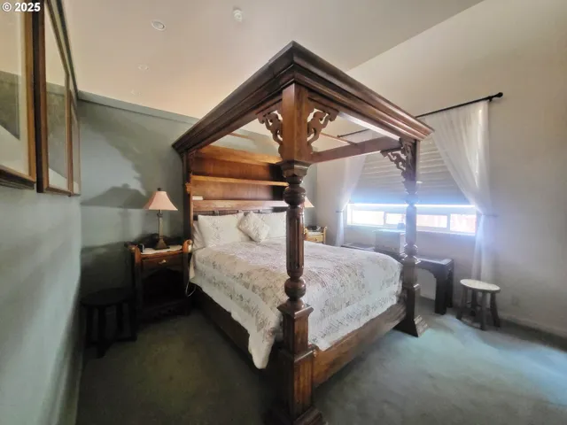a bed room with a bed and a chandelier