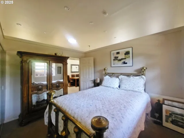 a bed room with a bed mirror and a desk