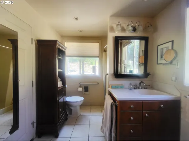 a bathroom with a toilet sink and mirror