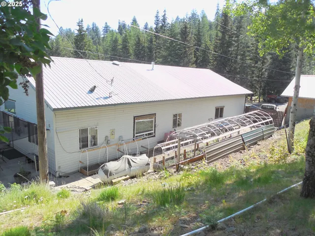 a aerial view of a house with a yard patio and furniture