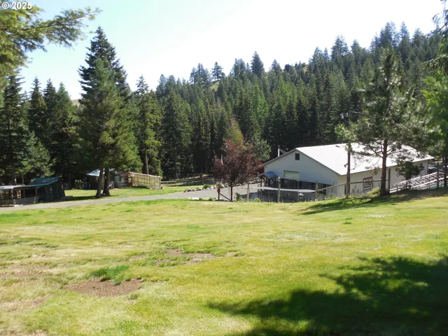 a swimming pool with trees in the background