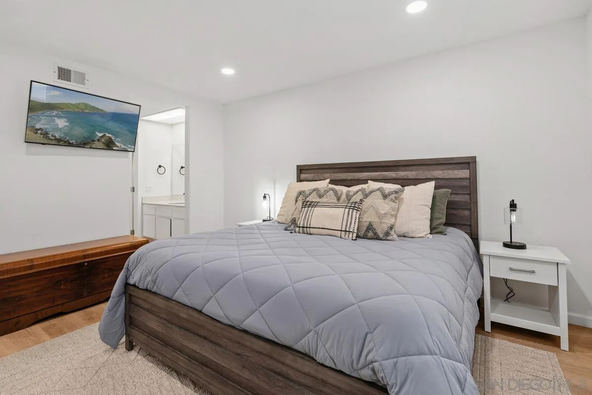 751 Pyramid Point Way Oceanside, CA 92058 - Photo 18 of 30 a bedroom with a bed and wooden floor