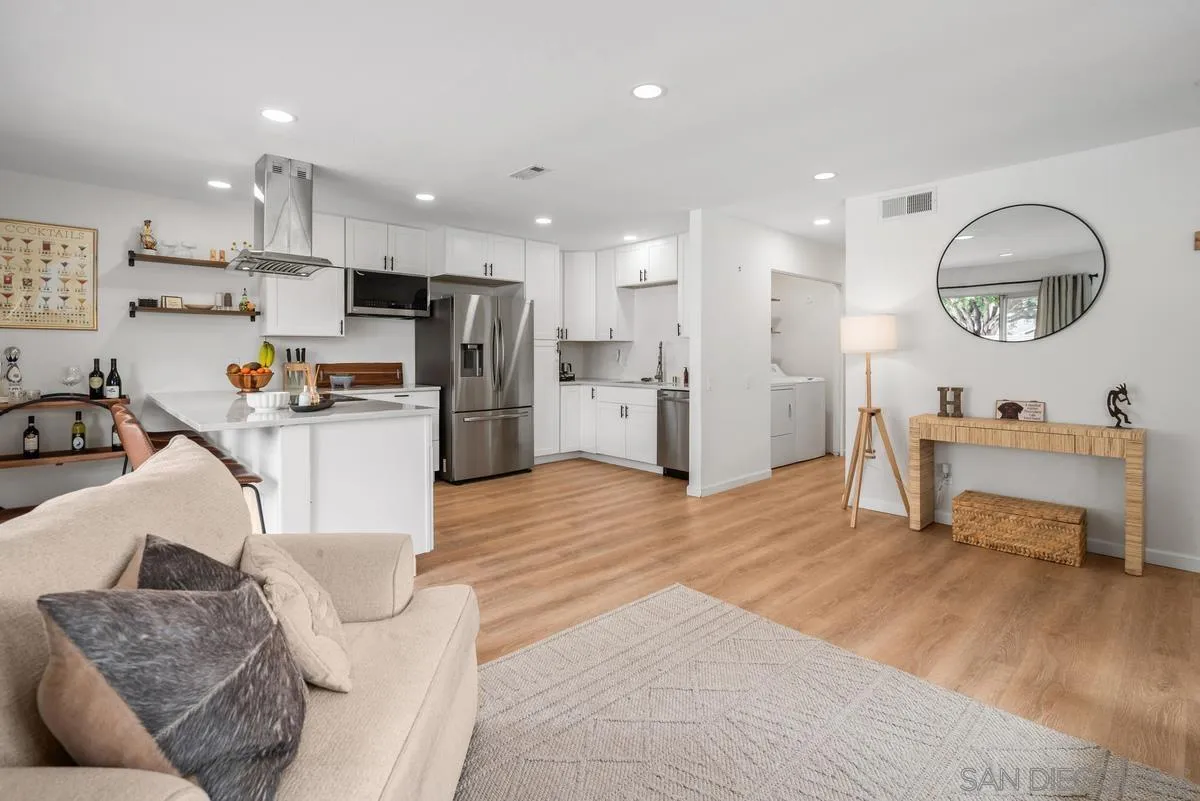 751 Pyramid Point Way Oceanside, CA 92058 - Photo 5 of 30 a living room with furniture and kitchen view with wooden floor