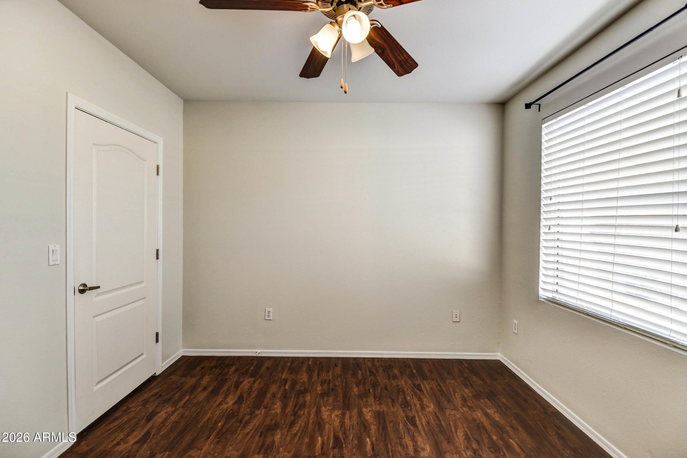 2134 East Broadway Road, Unit 1039 Tempe, AZ 85282 - Photo 15 of 24 wooden floor in an empty room with a window