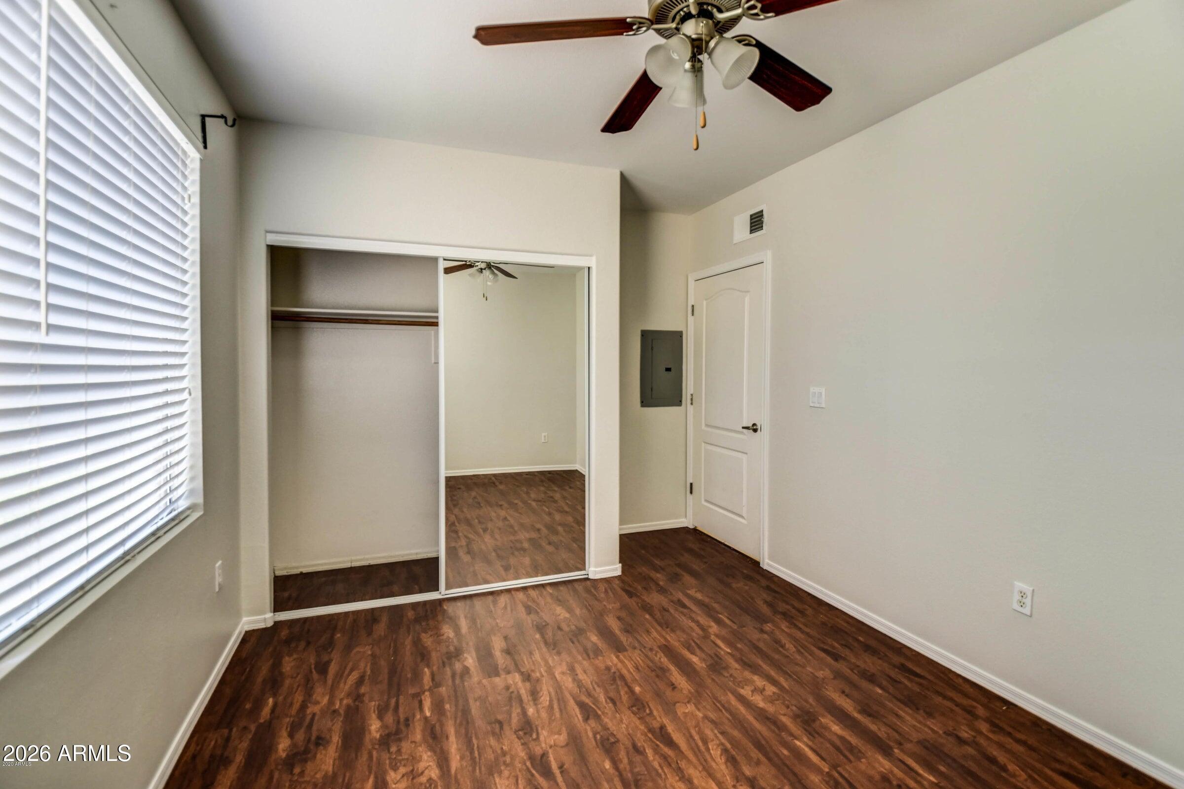 2134 East Broadway Road, Unit 1039 Tempe, AZ 85282 - Photo 16 of 24 wooden floor in an empty room with a window