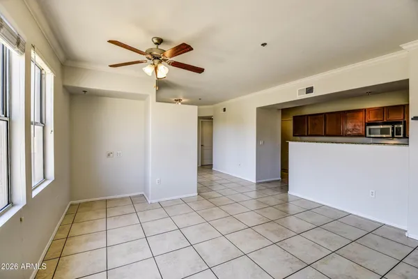 a view of a livingroom with a ceiling fan and window