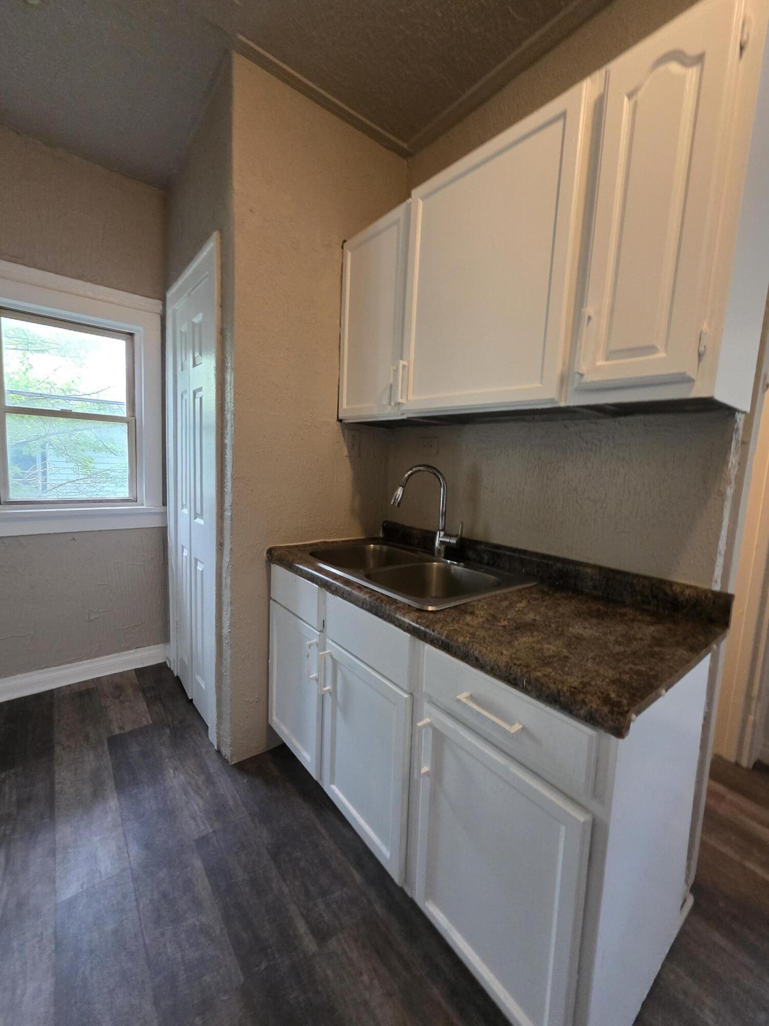 3946 Connecticut Street Gary, IN 46409 - Photo 11 of 20 a kitchen with granite countertop white cabinets and sink