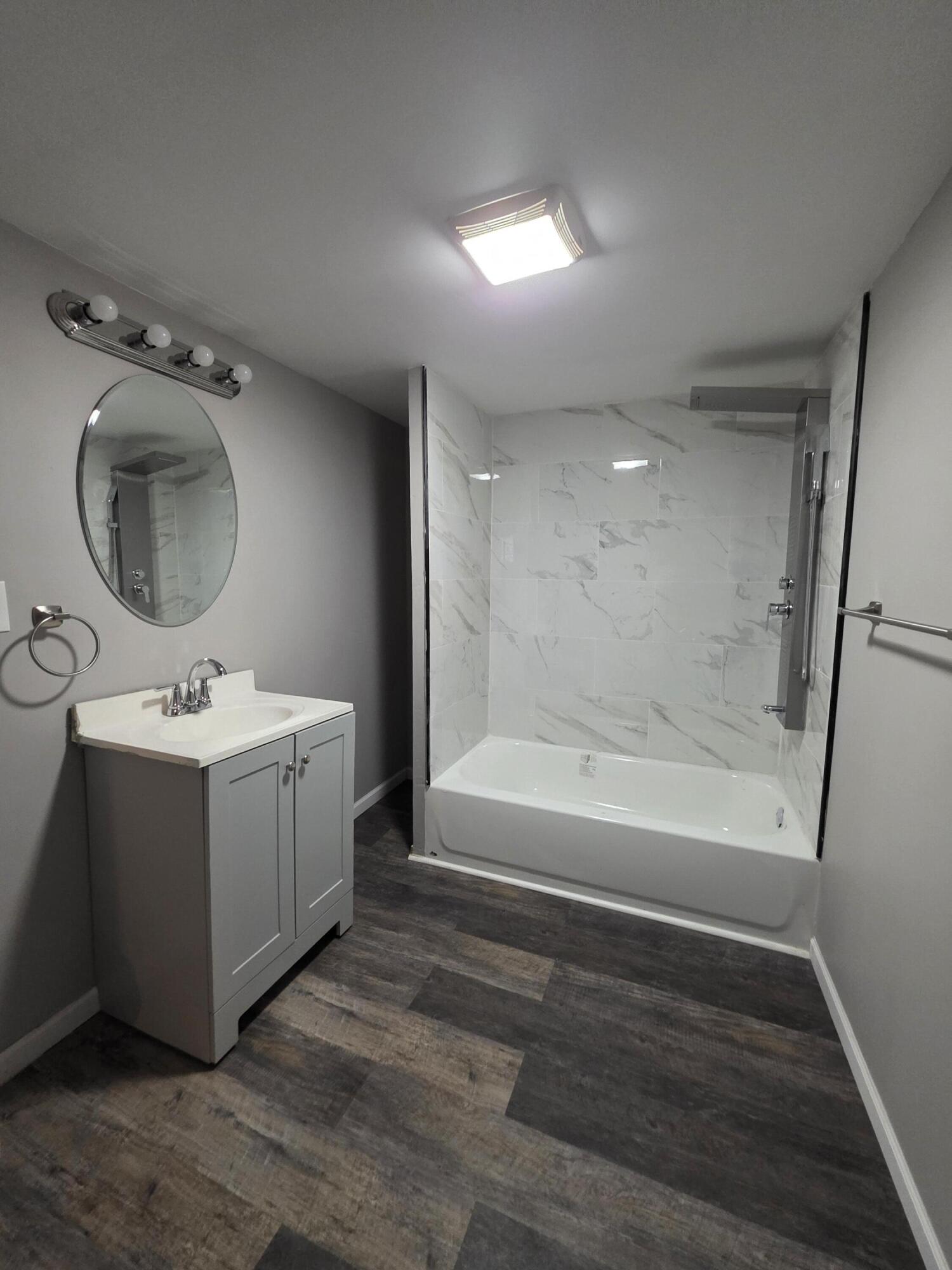 3946 Connecticut Street Gary, IN 46409 - Photo 14 of 20 a bathroom with a sink mirror vanity and bathtub