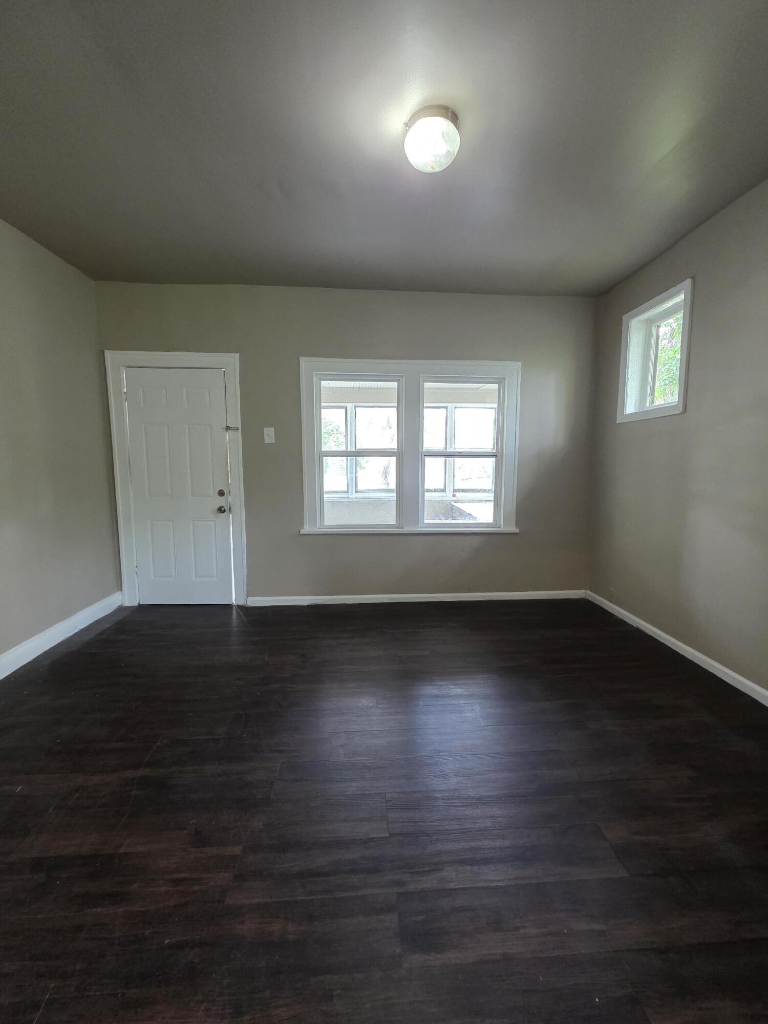 3946 Connecticut Street Gary, IN 46409 - Photo 5 of 20 an empty room with wooden floor and windows
