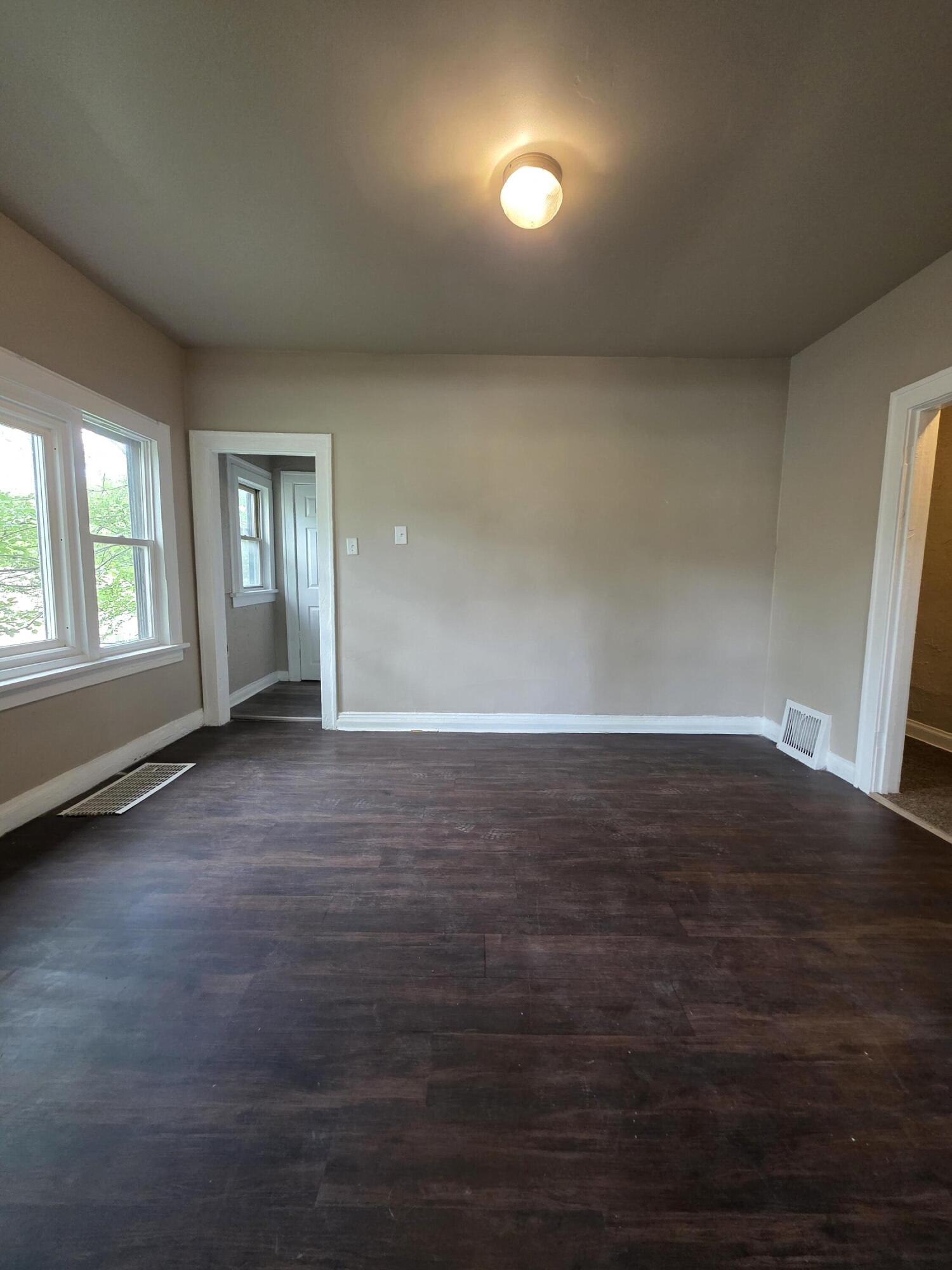 3946 Connecticut Street Gary, IN 46409 - Photo 6 of 20 an empty room with wooden floor and windows