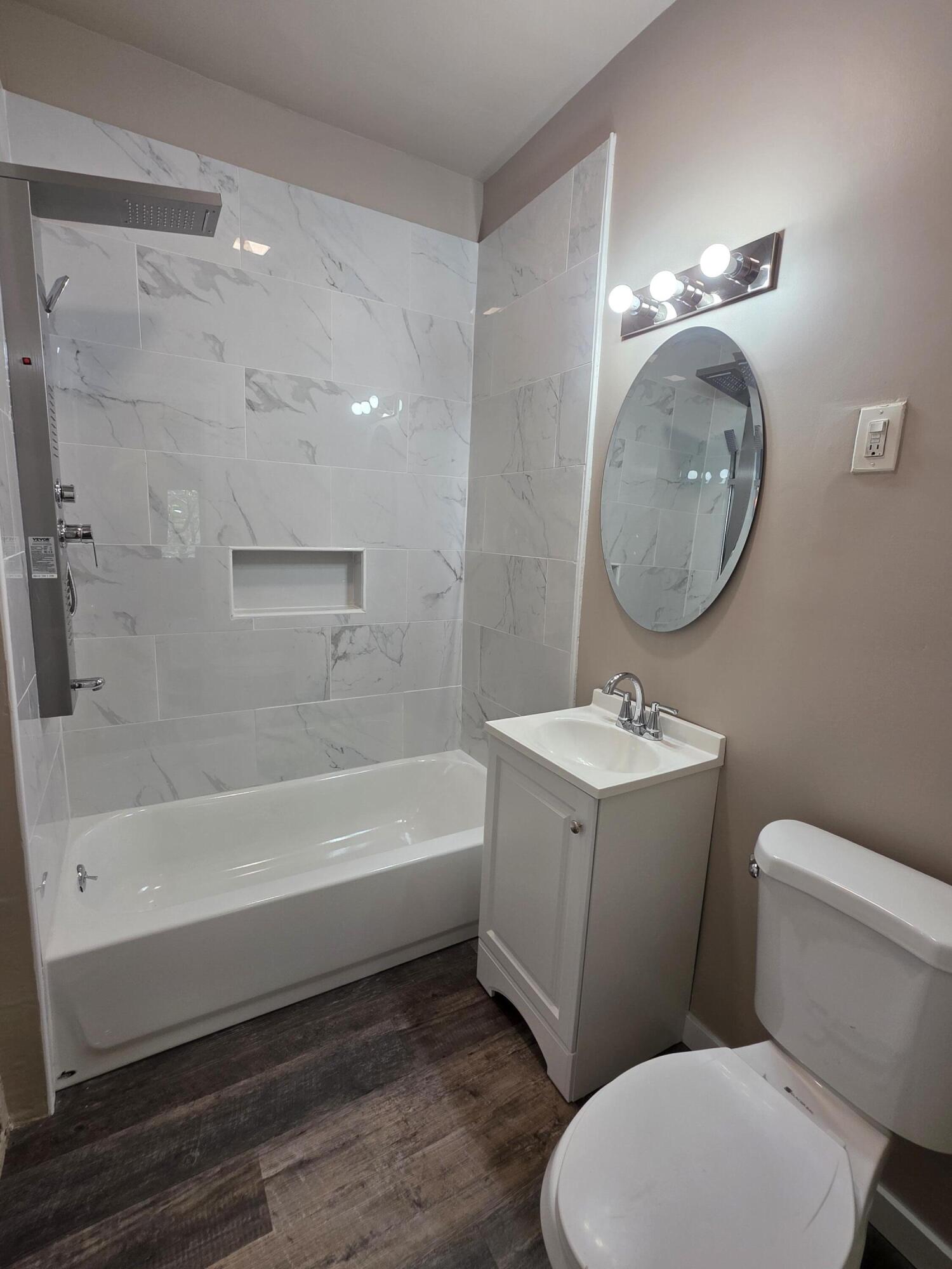 3946 Connecticut Street Gary, IN 46409 - Photo 8 of 20 a bathroom with a toilet a sink and bathtub