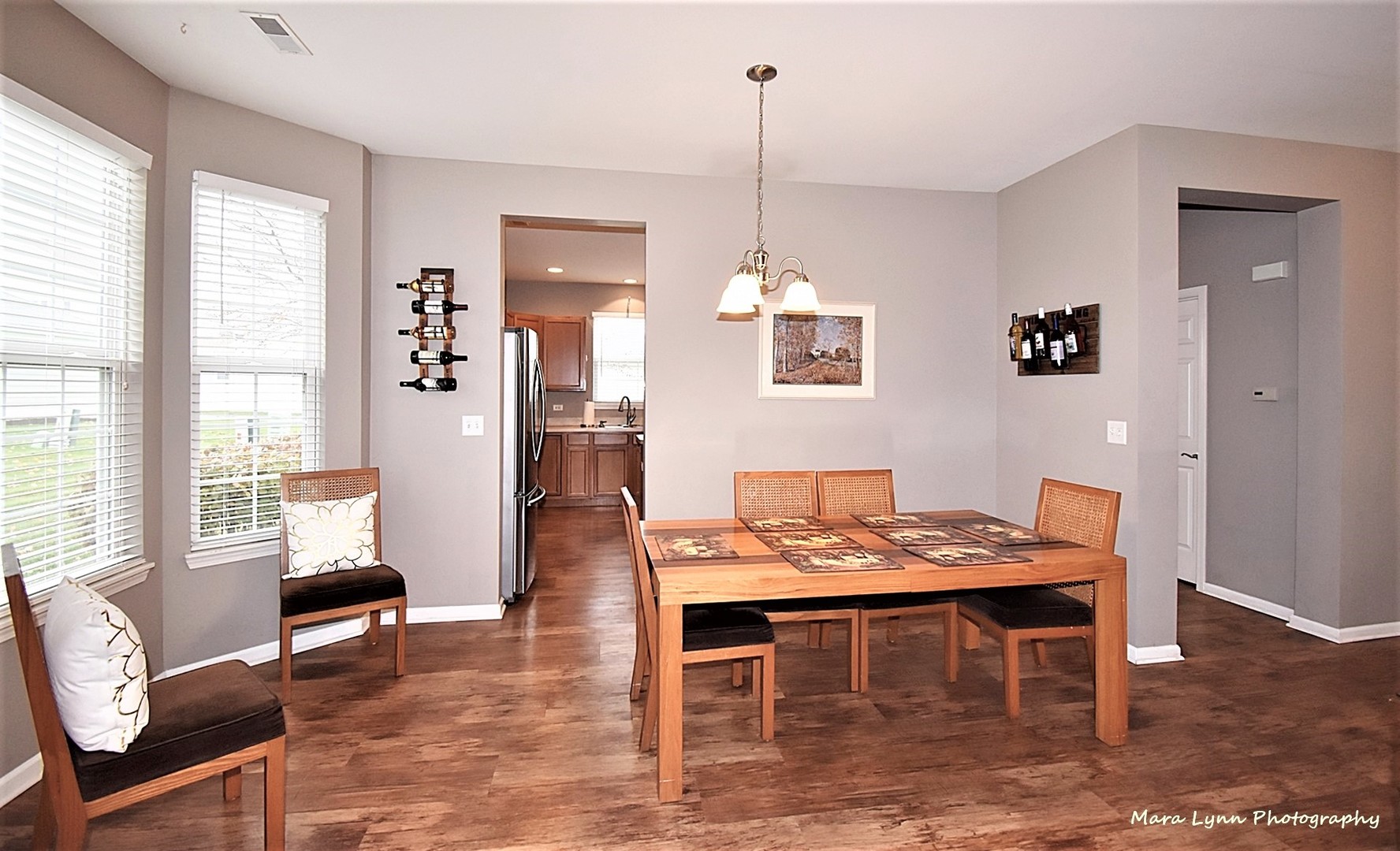 1240 Mariemont Road, Unit A Sugar Grove, IL 60554 - Photo 8 of 33 a dining room with furniture a chandelier and wooden floor
