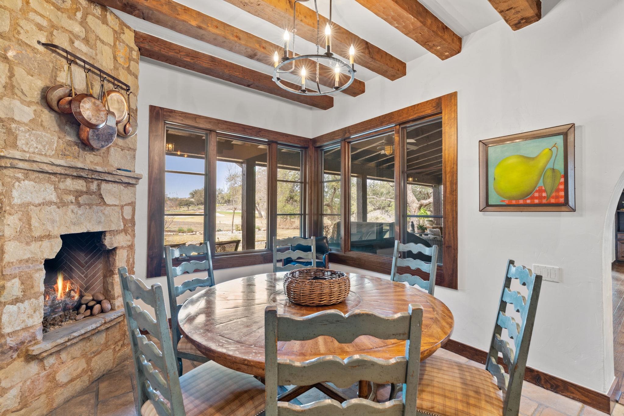 119 Plaza Escondido Horseshoe Bay, TX 78657 - Photo 12 of 30 a dining room with furniture a fireplace and large windows