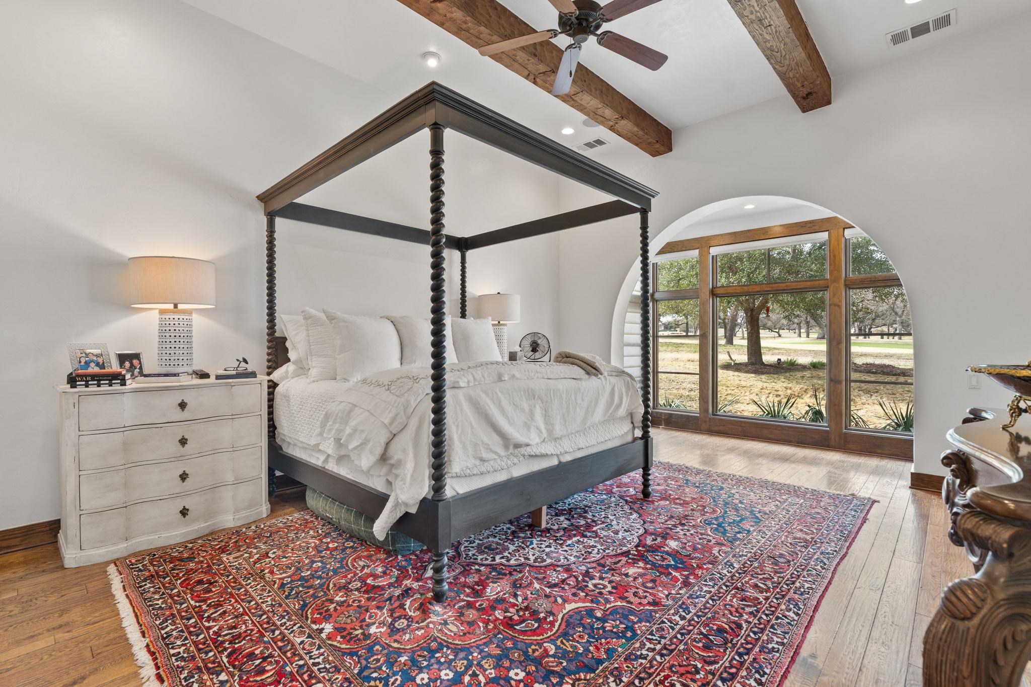 119 Plaza Escondido Horseshoe Bay, TX 78657 - Photo 13 of 30 a bedroom with a bed and a mirror