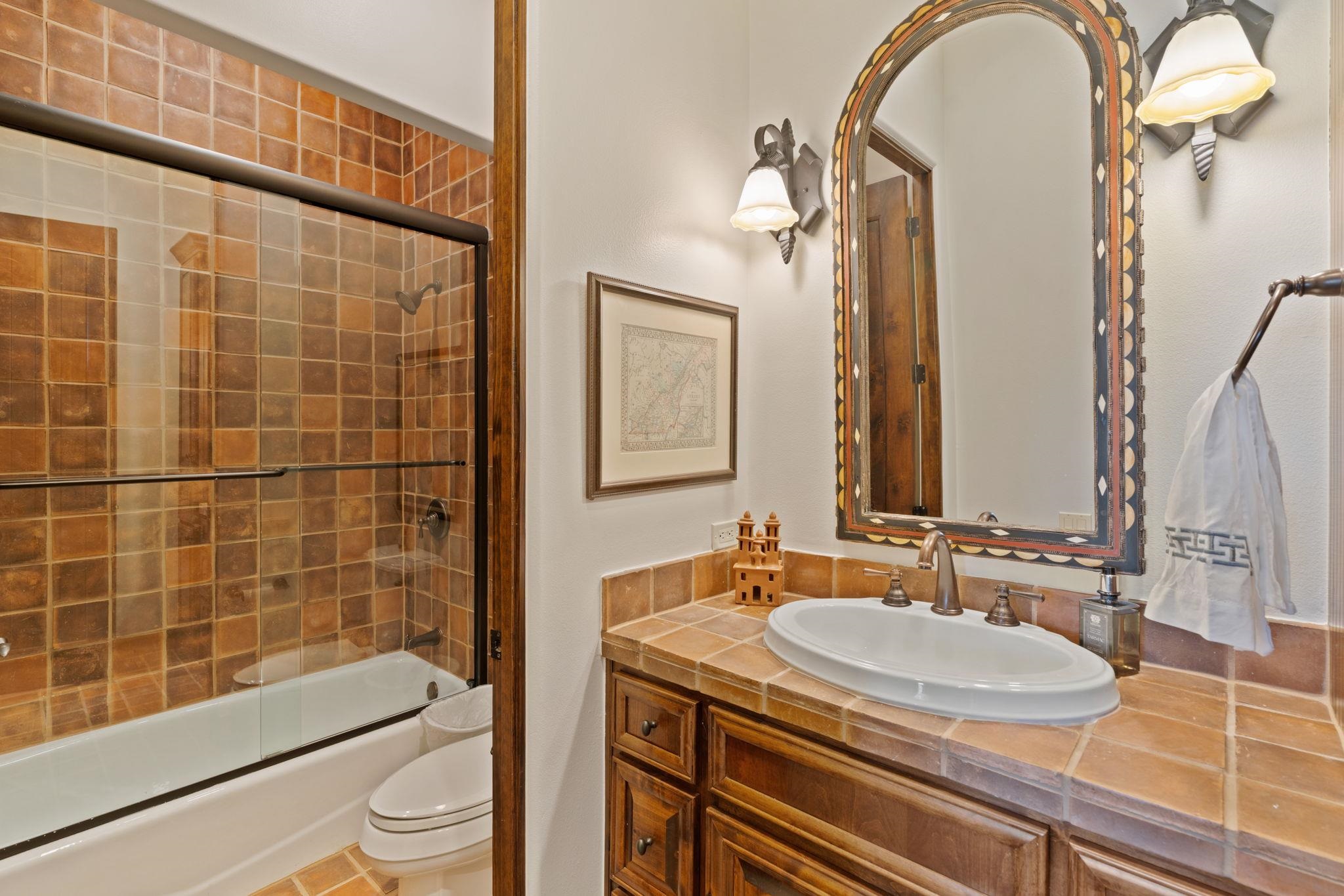 119 Plaza Escondido Horseshoe Bay, TX 78657 - Photo 19 of 30 a bathroom with a sink a toilet and shower