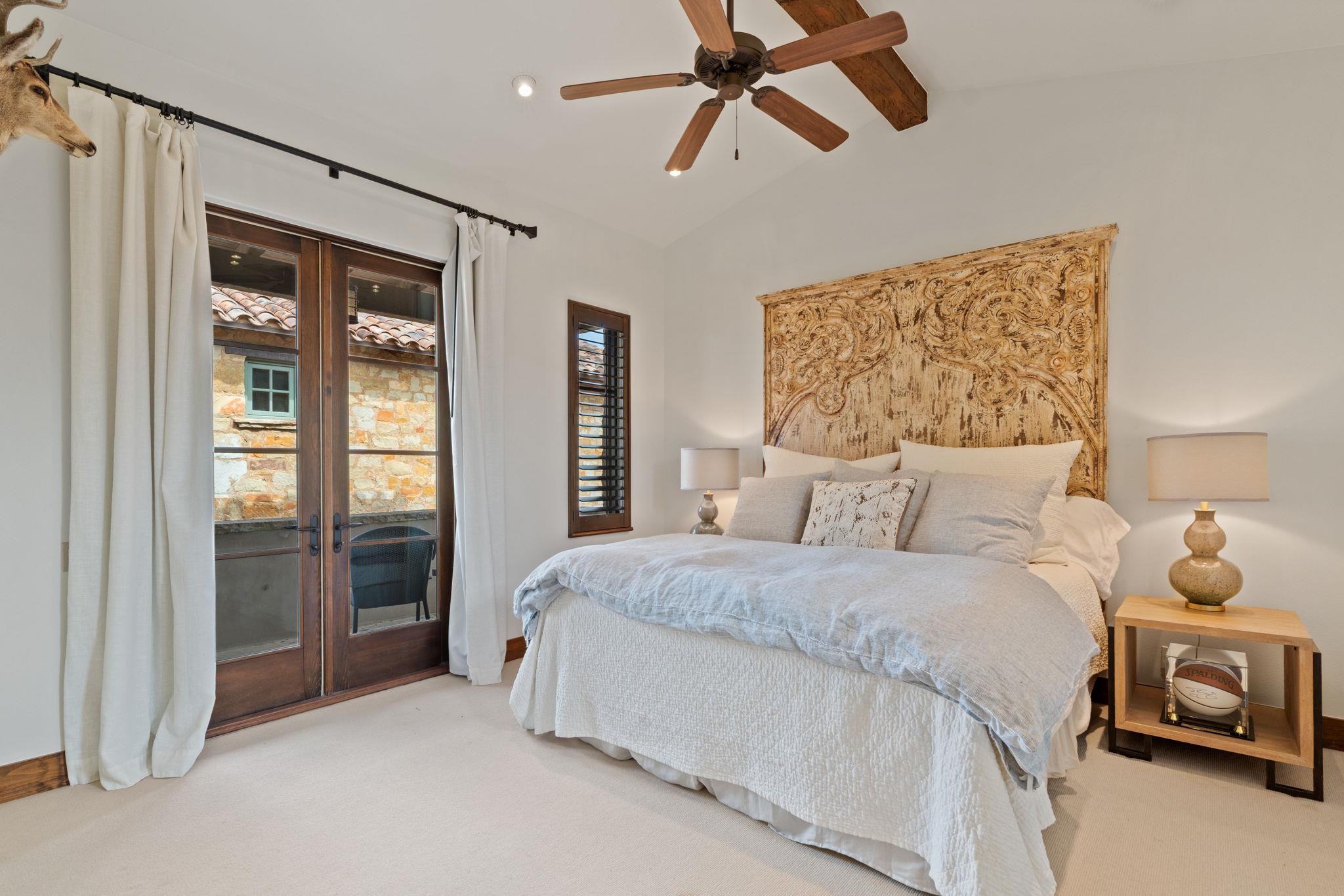 119 Plaza Escondido Horseshoe Bay, TX 78657 - Photo 22 of 30 a bedroom with a bed and a window