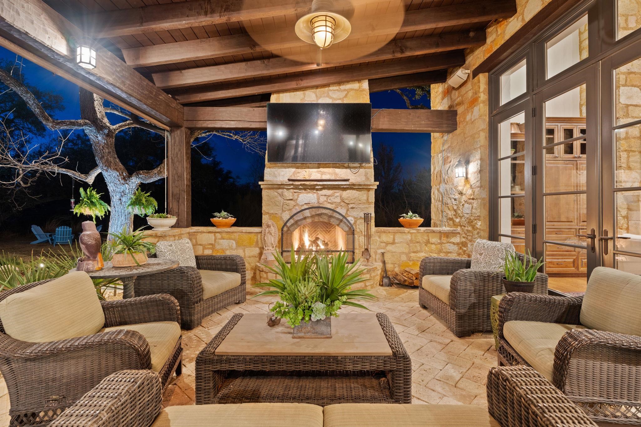 119 Plaza Escondido Horseshoe Bay, TX 78657 - Photo 23 of 30 a living room with furniture a fireplace and a chandelier