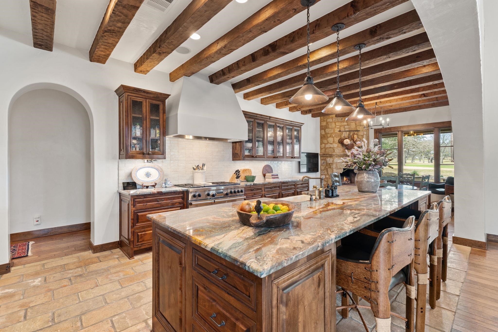 119 Plaza Escondido Horseshoe Bay, TX 78657 - Photo 9 of 30 a kitchen with a sink a stove and chairs
