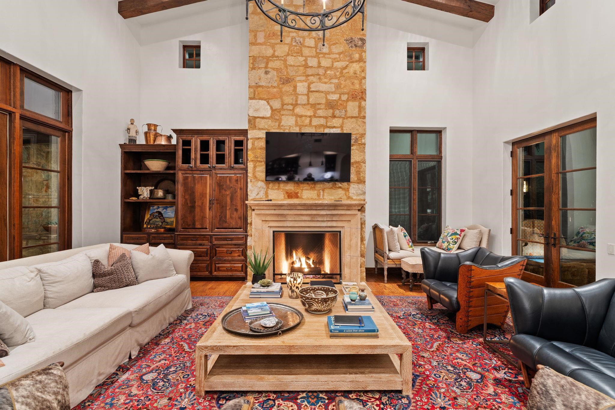119 Plaza Escondido Horseshoe Bay, TX 78657 - Photo 10 of 30 a living room with furniture a fireplace and a flat screen tv
