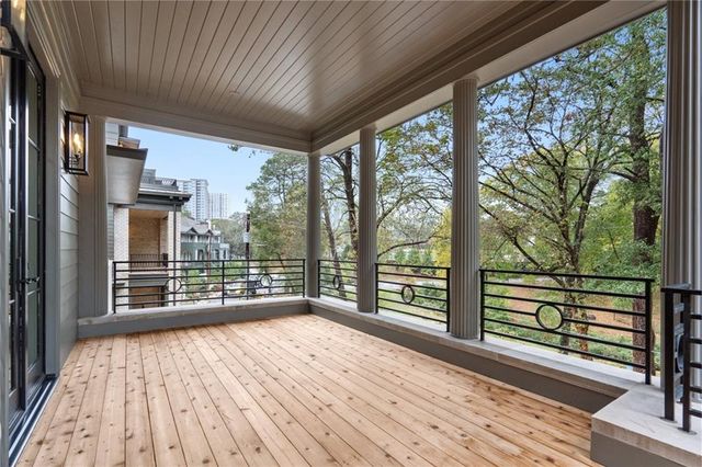 a view of a room with wooden floor and windows