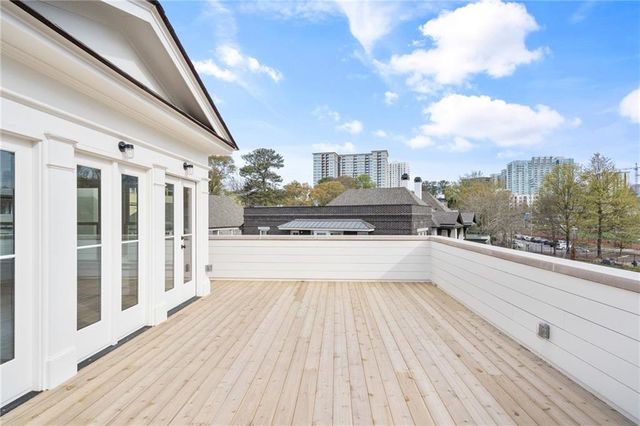 a view of a house with a swimming pool and sitting area