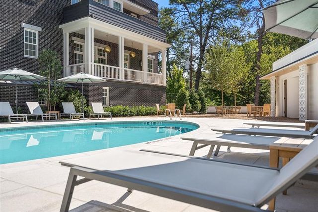 a view of backyard with table and chairs and couches