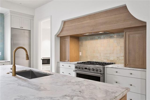 a kitchen with a stove and a sink