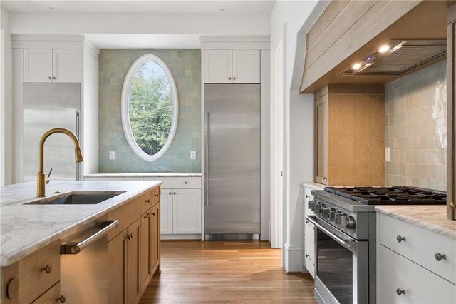 a kitchen with granite countertop a sink and a stove