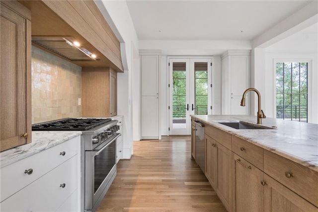 a kitchen with granite countertop a stove and a sink