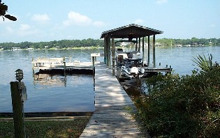 a view of a lake with a table and chairs