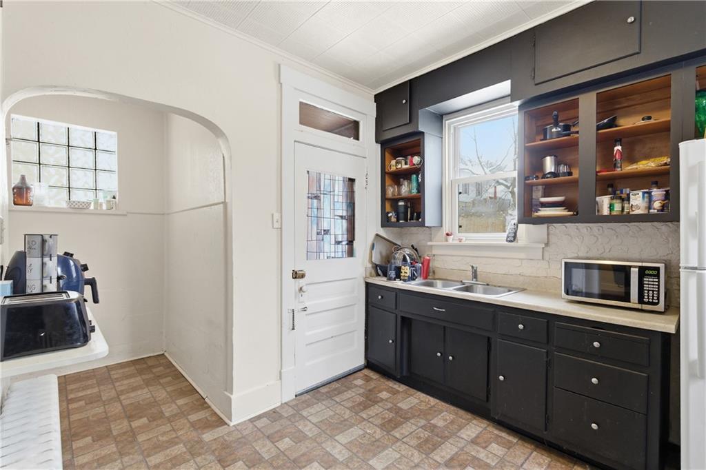 526 Dippold Avenue Baden, PA 15005 - Photo 12 of 26 a kitchen with stainless steel appliances granite countertop a sink and cabinets with wooden floor