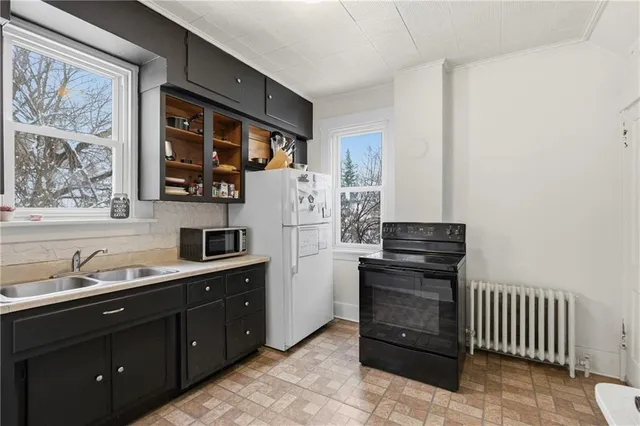 a kitchen with a refrigerator and a sink