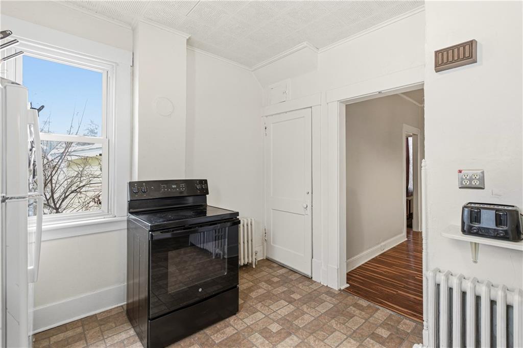 526 Dippold Avenue Baden, PA 15005 - Photo 14 of 26 a view of kitchen and empty room with a fireplace
