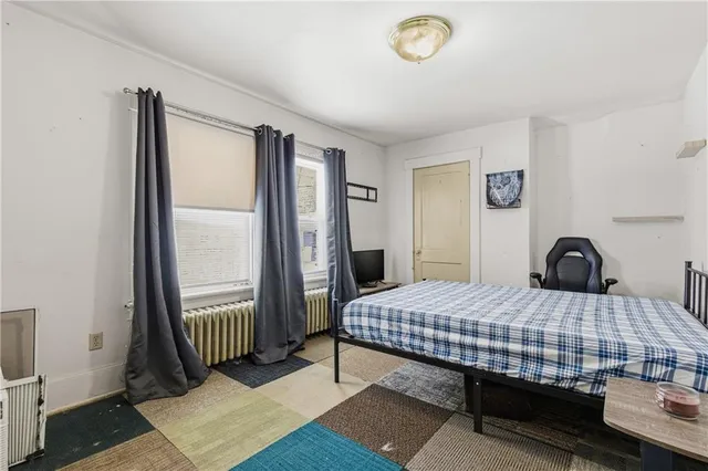 a bedroom with a bed and a window