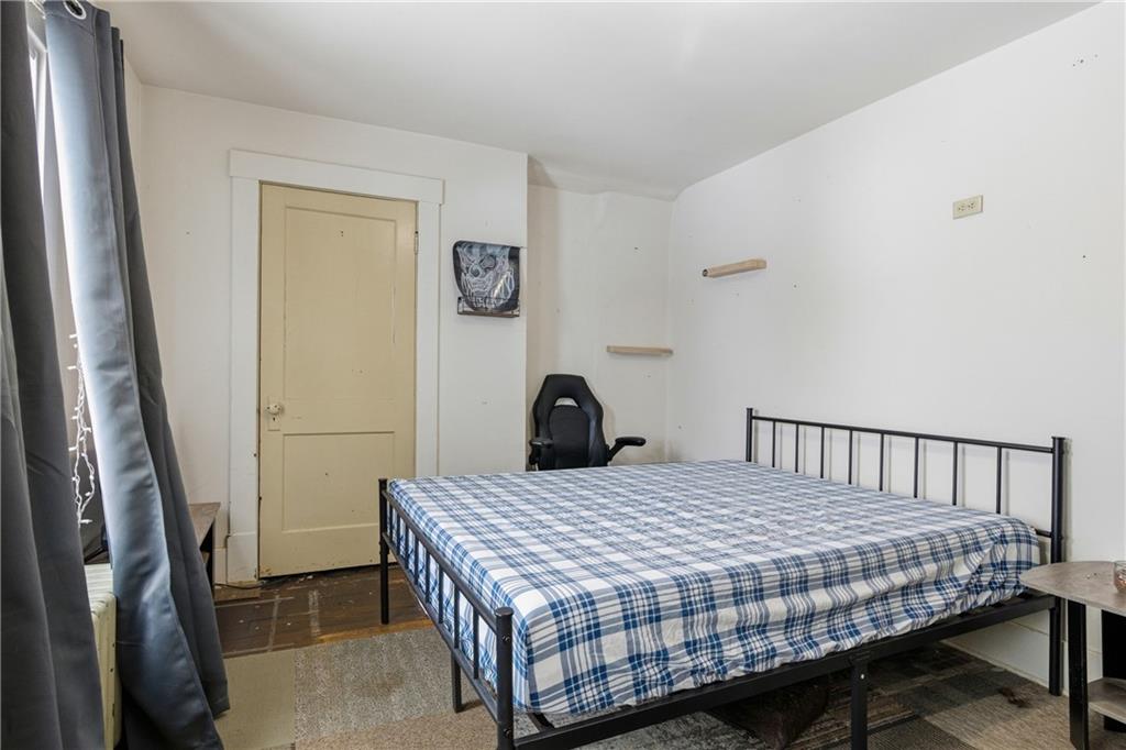 526 Dippold Avenue Baden, PA 15005 - Photo 18 of 26 a bedroom with a bed and wooden floor