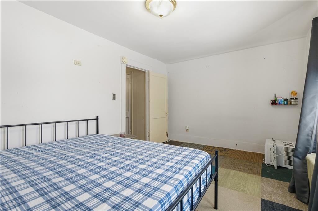 526 Dippold Avenue Baden, PA 15005 - Photo 19 of 26 a bedroom with a bed and a chandelier