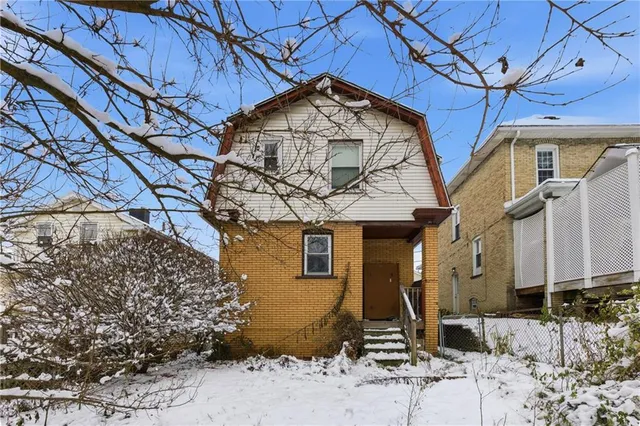 a view of a yard with a house and snow on the road