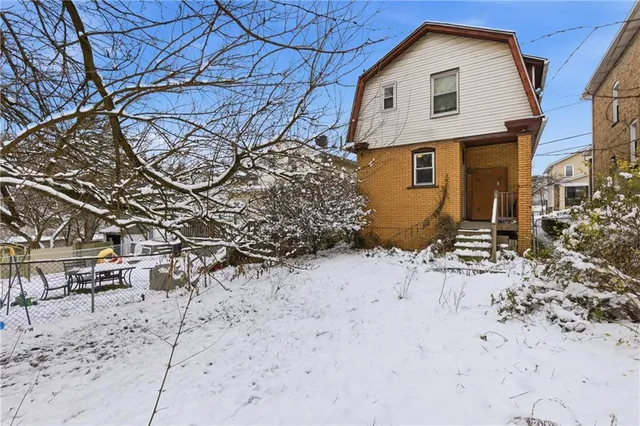 a view of snow on the yard