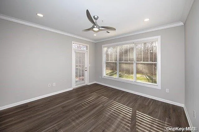 an empty room with windows and closet