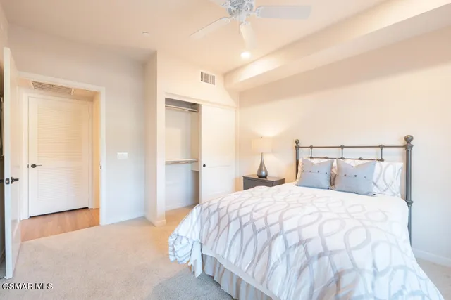 a bedroom with a bed and a painting