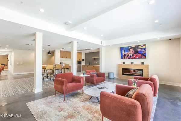 a living room with furniture a rug and a fireplace